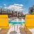 2 yellow chairs by a pool